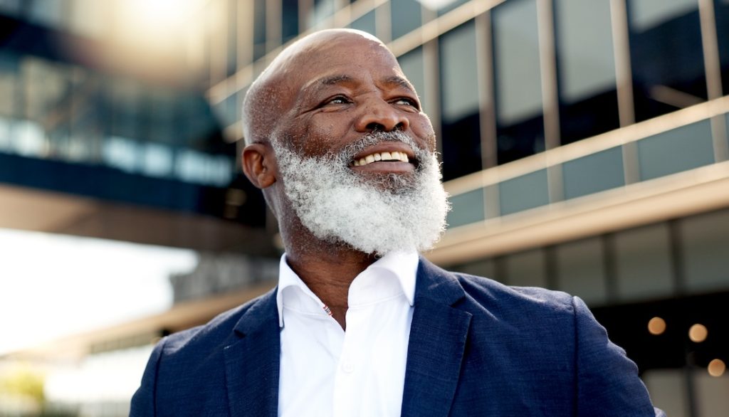 Mature black businessman outside office building