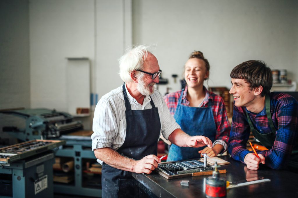 Senior craftsman teaching workshopw