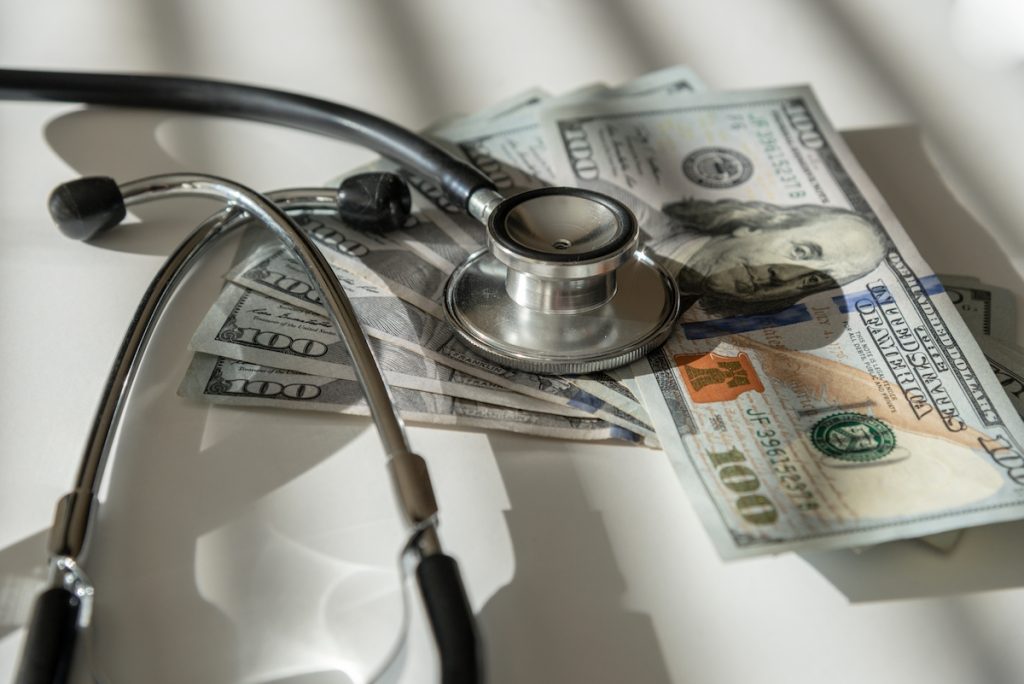 Stethoscope on top of cash money